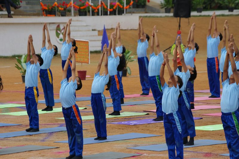 Students doing yoga together on the school ground