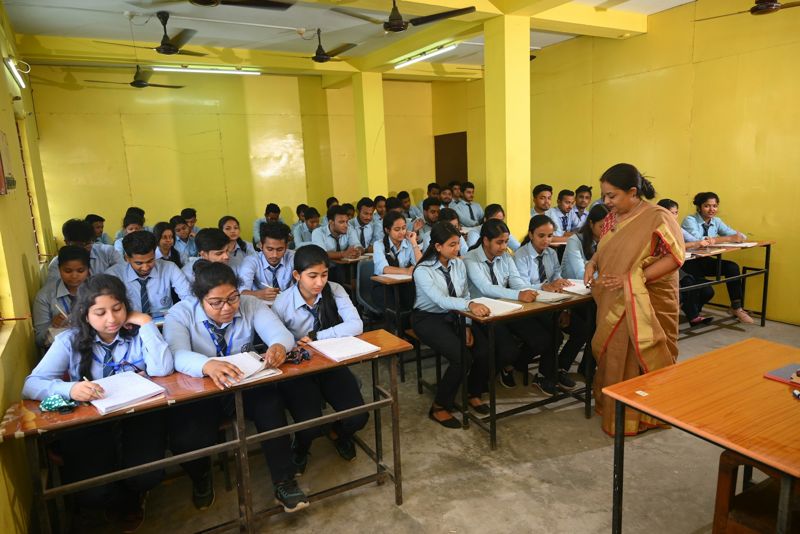 A full classroom of students in uniform