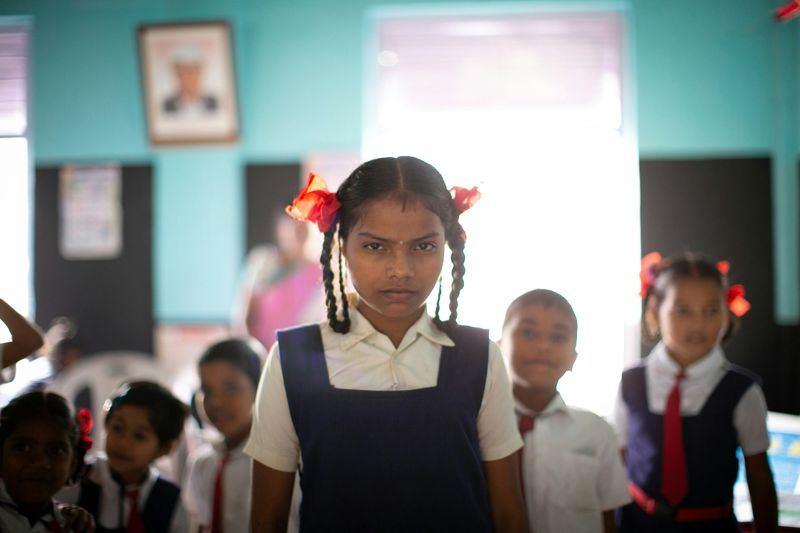A young student in uniform smiling